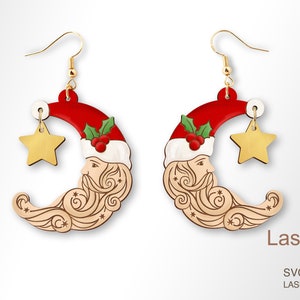 May include: A pair of red, white, and gold Christmas-themed earrings featuring a Santa Claus face on a crescent moon with a star charm. The earrings are laser-cut and ready to be assembled.