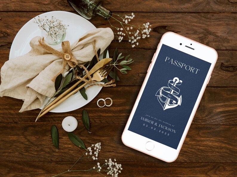 May include: A navy blue phone screen with a white anchor and ribbon with the text "PASSPORT" and "Join us for the wedding of Amber & Jackson 05.03.2023".