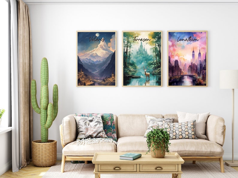 May include: Three framed watercolor paintings with different landscapes. The first painting depicts a mountain range with a village at the base. The second painting shows a forest with a castle in the background and a deer standing in a river. The third painting shows a city skyline with a bridge and a river.
