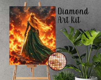 May include: A Diamond Art Kit featuring a rectangular canvas on a wooden easel. The artwork depicts a figure with long blonde hair wearing a crown and a green gown, holding a sword amidst a backdrop of intense orange and yellow flames.