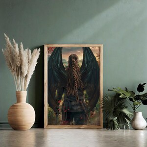 May include: A framed fantasy art print featuring a person with long brown hair and large black wings standing in a forest setting.