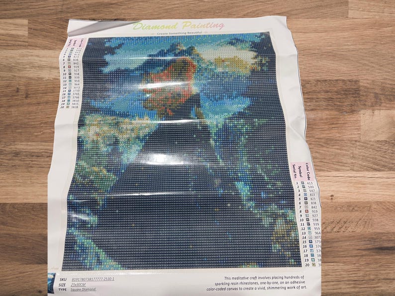 May include: A diamond painting kit featuring a colorful image of a person in a landscape. The kit includes a canvas, rhinestones, and instructions. The text "Diamond Painting" is visible at the top.