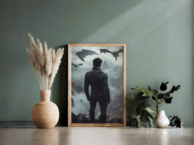 May include: A framed print of a man standing in a misty landscape with three black dragons flying overhead. The man is wearing a black leather jacket and jeans. The print is in a wooden frame.