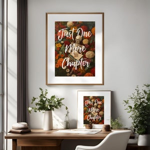 May include: Two framed prints with the text "Just One More Chapter" in white lettering on a background of a skeleton surrounded by colorful flowers.