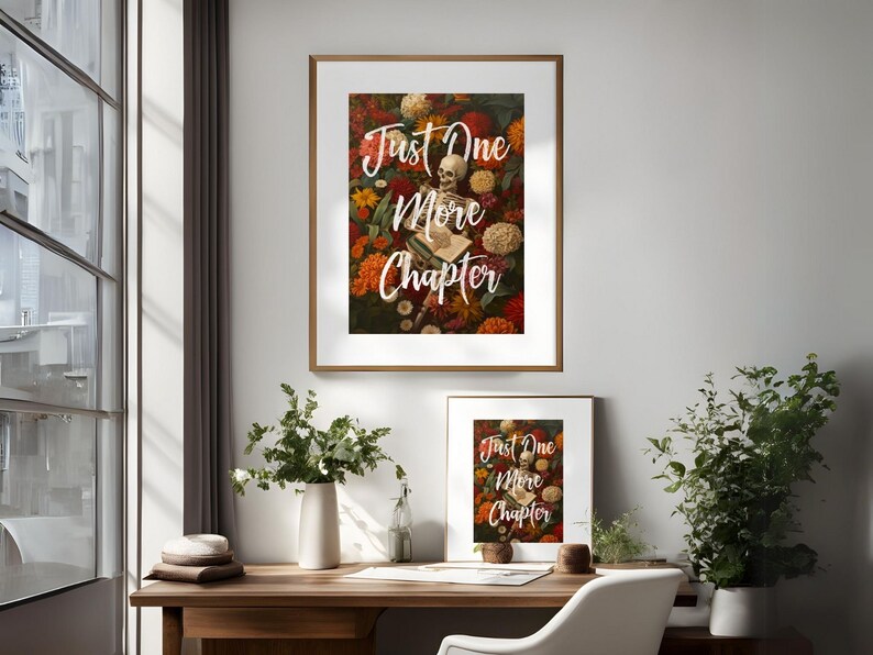 May include: Two framed prints with the text "Just One More Chapter" in white lettering on a background of a skeleton surrounded by colorful flowers.