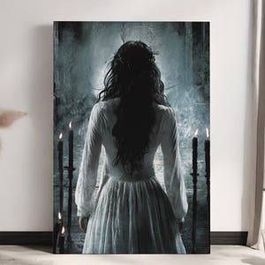 May include: A woman in a white dress with long black hair stands in front of a dark, misty background. She is surrounded by four lit candles.