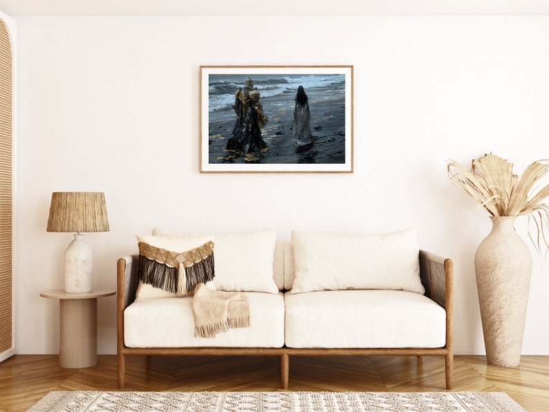 May include: A framed photograph of two figures in long flowing robes walking on a beach. The figures are silhouetted against a stormy sky and the ocean waves. The beach is dark and wet.
