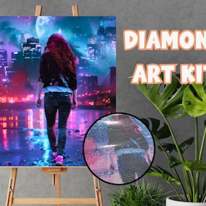 May include: Diamond art kit featuring a woman walking away from the viewer in a city at night. The artwork is displayed on an easel. The kit includes a close-up of the diamond art. The words "DIAMOND ART KIT" are displayed in orange.