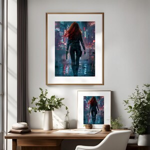 May include: A framed print of a woman with red hair walking down a city street at night. The woman is wearing a black leather jacket and jeans. The city is lit up with neon lights.