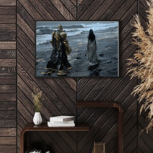 May include: A framed print of a painting depicting a knight in armour walking away from a woman in a white dress on a beach. The knight is wearing gold armour and a black cloak. The woman is walking towards the ocean. The background is a stormy sea.