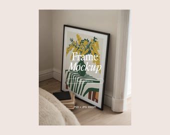 May include: A framed art print leaning against a wall, featuring a floral still life in a green vase on a table with a striped tablecloth. The frame is black, and the image includes the text "Frame Mockup".