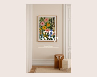 May include: A framed floral art print with a wooden frame hangs on a cream wall. The artwork features colourful flowers in pink, yellow, and blue. The text "Frame Mockup" is overlaid, along with "Smart Objects". A small wooden stool and a side table are below.