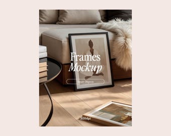 May include: A black picture frame mockup with a print of a person in a seated pose. The frame is on a wooden surface with a white faux fur throw and a black side table with books.