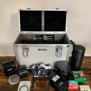 Canon AE-1 Manual Camera with strap, Large Canon case, 5 lenses, photoflash, and 35mm Film, Filters, Extras - Nice Vintage Canon Camera!