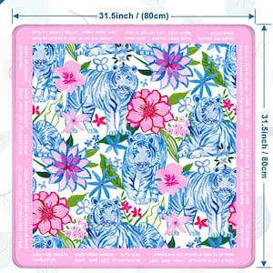 May include: A square decorative mat with a white background featuring blue tigers, pink flowers, and blue floral accents. The mat measures 80cm on each side. The border is pink with text.