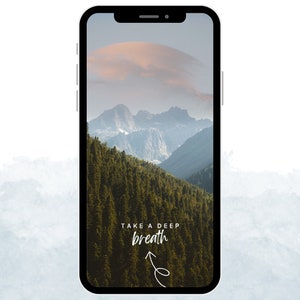 May include: A phone screen with a mountain range and forest in the background. The text "TAKE A DEEP breath" is written on the screen with an arrow pointing upwards.