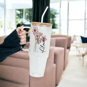 Birth Flower Personalized Tumbler with Lid and Straw, February violet colour birth flower, personalized with a name, 40oz glass tumbler held in hand at home