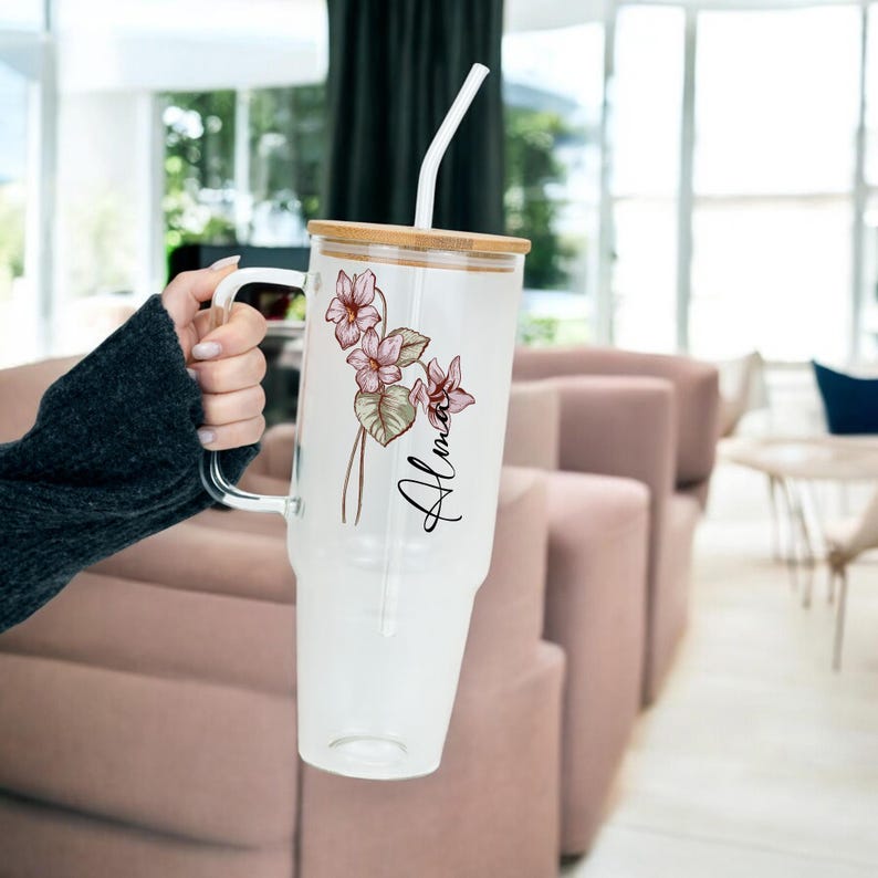 Birth Flower Personalized Tumbler with Lid and Straw, February violet colour birth flower, personalized with a name, 40oz glass tumbler held in hand at home