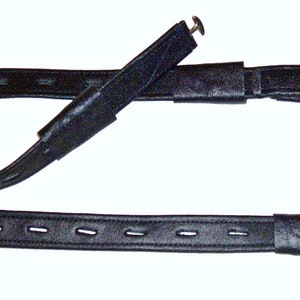May include: Black leather horse reins with a buckle and a loop at one end. The reins are adjustable and have a smooth finish.