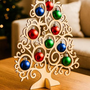 May include: Wooden Christmas tree decoration with a star on top, adorned with red, green, and blue ornaments. The tree has a decorative, openwork design and stands on a wooden table. A festive holiday accent.