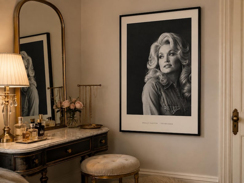 May include: A black and white framed portrait print of Dolly Parton featuring her signature voluminous hair and a denim shirt. The print is displayed in a thin black frame with the text DOLLY PARTON TENNESSEE printed at the bottom center.