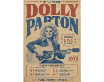 May include: A vintage-style concert poster featuring Dolly Parton playing an acoustic guitar. The text reads IN CONCERT DOLLY PARTON, APPEARING LIVE ON STAGE, 1973, and a list of 1973 tour dates, ending with PURE COUNTRY MUSIC. The design uses red and blue.