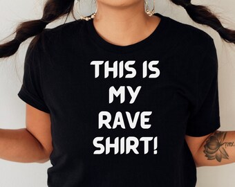 May include: A black t-shirt with white text that reads "This is my rave shirt!"
