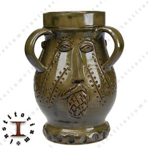 May include: A green ceramic mug with a face and a beard. The mug has two handles and a textured surface.