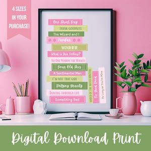May include: A framed digital print with song titles from a musical, in pink, green, and white. The print is on a white desk with pink accessories and greenery. The text "Digital Download Print" is at the bottom of the image.