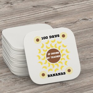 May include: A stack of white square coasters with a design of yellow bananas and the text "100 days of driving my teacher bananas".
