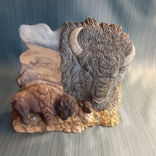 Buffalo Statue/Figurine  Magestic  Adult Buffalo with a calf  Wilderness Prairie Sky Background   Large Buffalo Head Overshadowing the scene