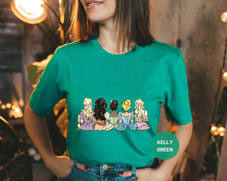 a woman wearing a green t - shirt with cartoon characters on it
