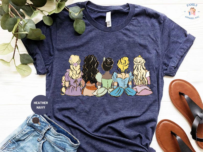 a women's t - shirt with a picture of disney princesses on it