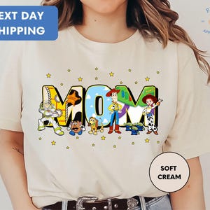 a woman wearing a t - shirt with the word mom printed on it