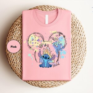 a pink shirt with a mouse on it