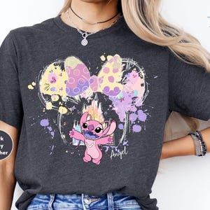 a woman wearing a t - shirt with a cartoon character on it