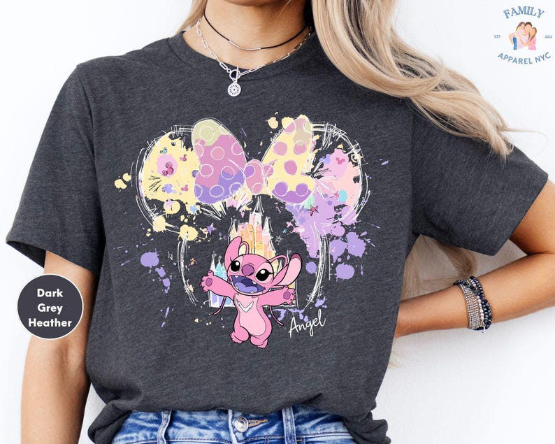 a woman wearing a t - shirt with a cartoon character on it