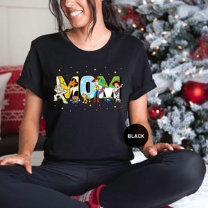 a woman sitting on a bed in front of a christmas tree