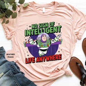 a pink t - shirt with an image of a cartoon character saying no sign of