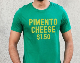 May include: A green t-shirt with the text "PIMENTO CHEESE $1.50" in yellow.