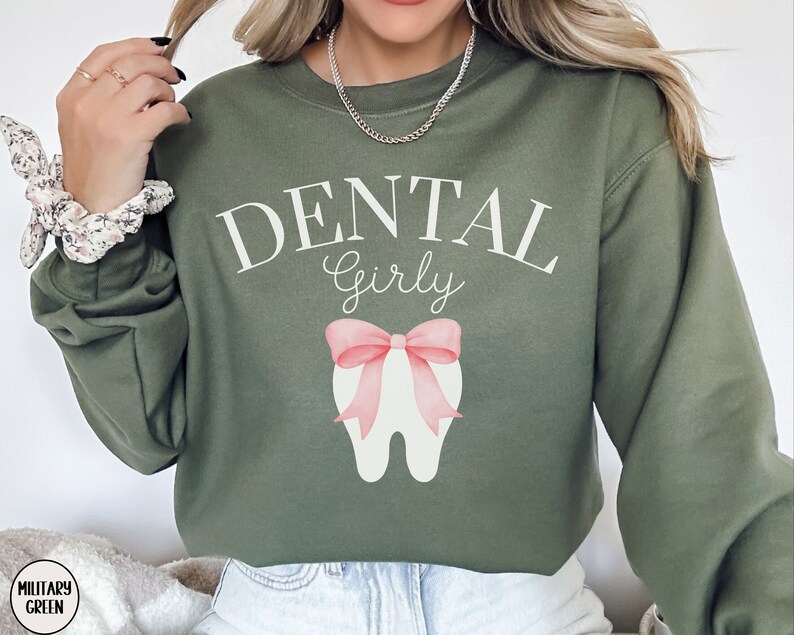 May include: A green sweatshirt with the text "Dental Girly" and a pink bow on a white tooth graphic.