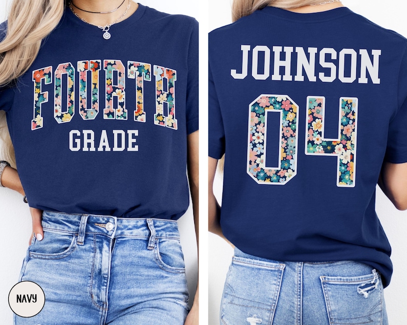May include: Navy blue t-shirt with "FOURTH GRADE" in white block letters. The word "FOURTH" is filled with a floral pattern. The back of the shirt has "JOHNSON 04" in white block letters, with the "04" also filled with the floral pattern.