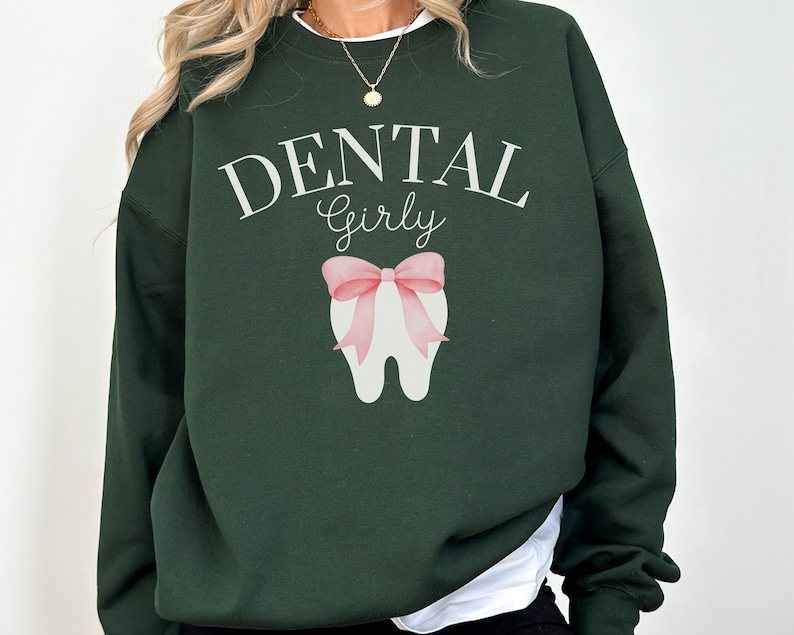 May include: A dark green sweatshirt with the text "DENTAL Girly" and a white tooth with a pink bow on it.
