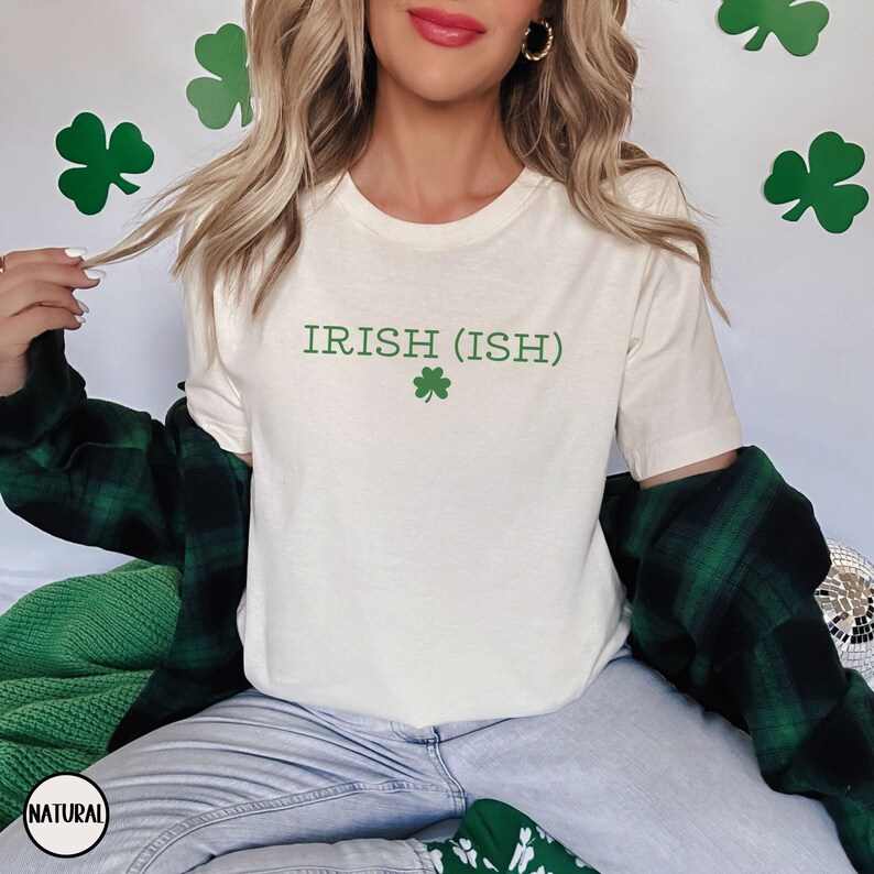 May include: A white t-shirt with the text "IRISH (ISH)" and a green shamrock printed on the front.