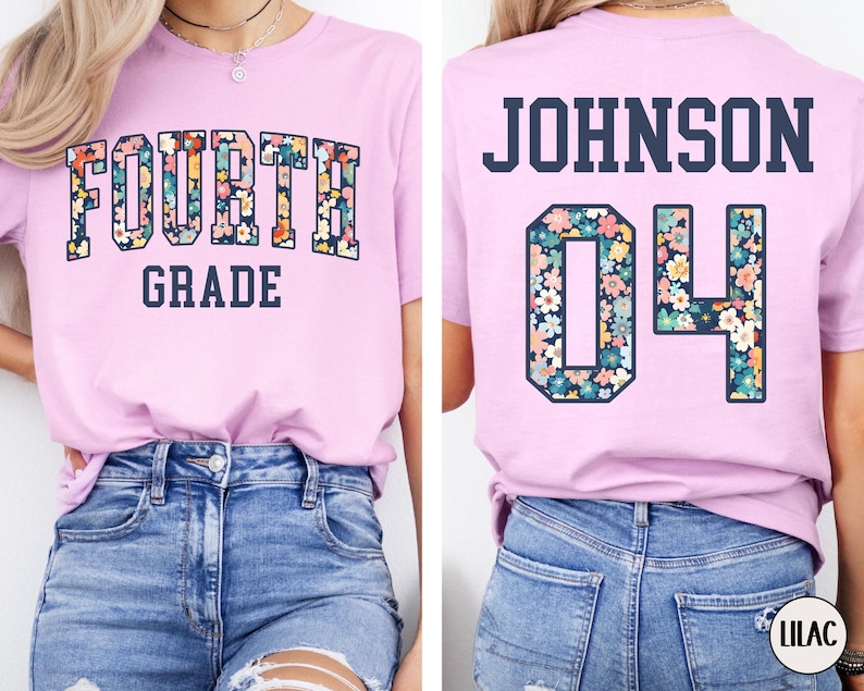 May include: A light pink t-shirt with the words "FOURTH GRADE" in a floral design on the front. The back of the shirt has the name "JOHNSON" and the number "04" in a floral design.
