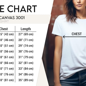 Op de afbeelding: Wit unisex T-shirt met een maattabel. De tabel toont borst- en lengtematen in centimeters voor de maten XS tot 5XL. De tekst op de tabel luidt "BELLA CANVAS 3001 UNISEX T-SHIRT".