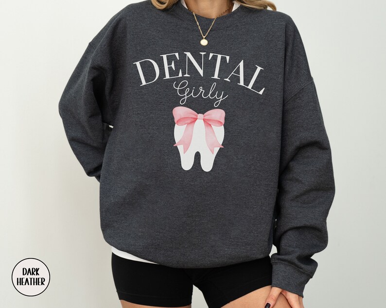 May include: Dark heather grey sweatshirt with the text "Dental Girly" and a pink bow on a white tooth graphic.