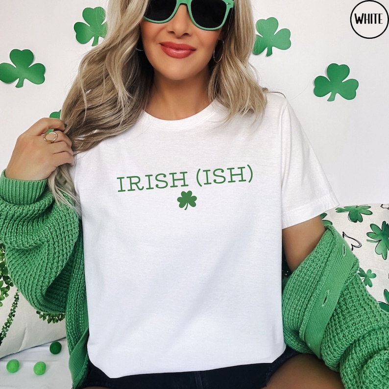 May include: White t-shirt with the text "IRISH (ISH)" and a green shamrock.