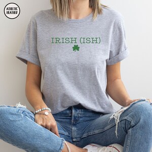 May include: A gray t-shirt with the text "IRISH (ISH)" and a green shamrock.