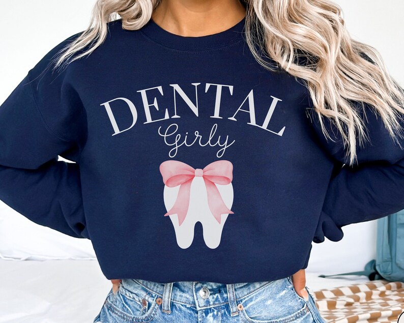 May include: Navy blue sweatshirt with the text "Dental Girly" and a white tooth with a pink bow.